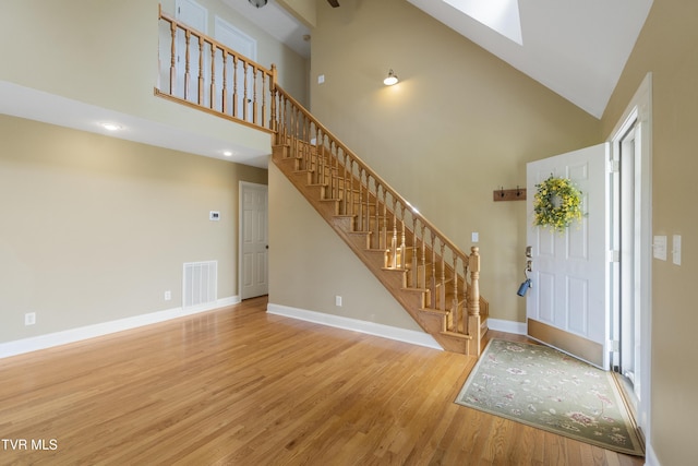 2361 Old Stage Rd, Afton, TN 37616 - foyer entrance with high vaulted ceiling, a skylight, wood finished floors, stairs, and baseboards