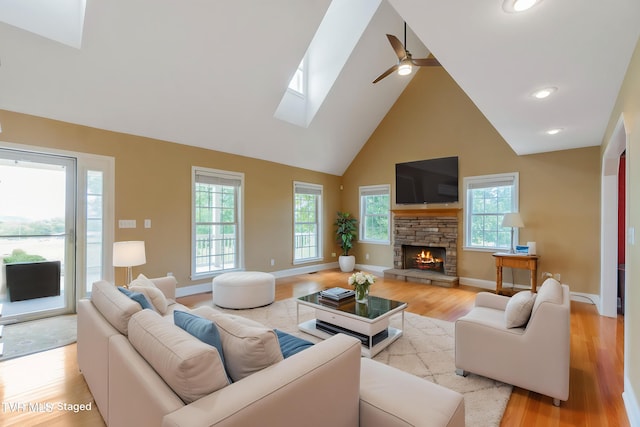 2361 Old Stage Rd, Afton, TN 37616 - living area with high vaulted ceiling, a skylight, light wood finished floors, ceiling fan, and a fireplace