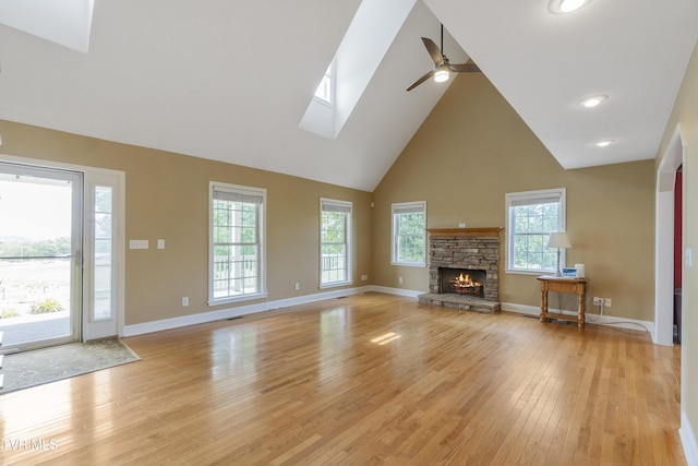 2361 Old Stage Rd, Afton, TN 37616 - unfurnished living room featuring a ceiling fan, a skylight, high vaulted ceiling, light wood-type flooring, and baseboards