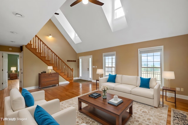 2361 Old Stage Rd, Afton, TN 37616 - living room featuring a skylight, wood finished floors, ceiling fan, baseboards, and high vaulted ceiling