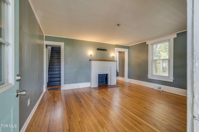 905 Kentucky Ave, Bristol, TN 37620 - unfurnished living room with wood-type flooring, a fireplace, and ornamental molding