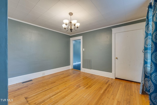 905 Kentucky Ave, Bristol, TN 37620 - empty room featuring crown molding, a chandelier, and hardwood / wood-style flooring