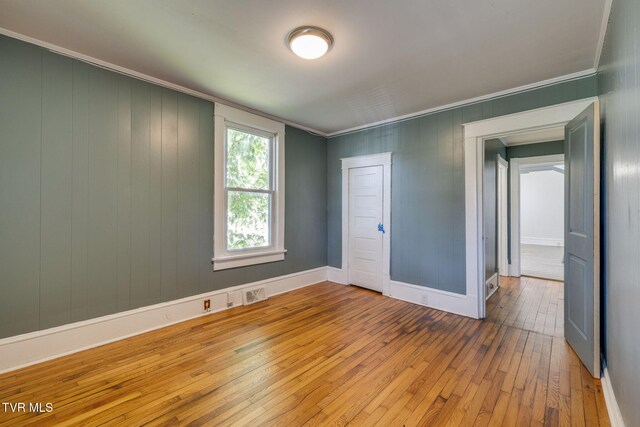 905 Kentucky Ave, Bristol, TN 37620 - unfurnished room featuring hardwood / wood-style floors, crown molding, and wooden walls