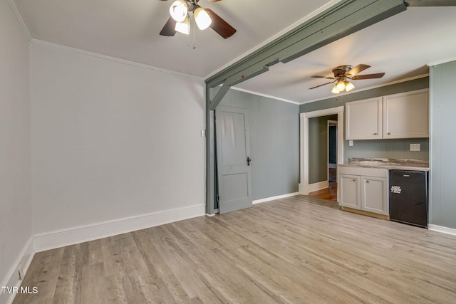 905 Kentucky Ave, Bristol, TN 37620 - unfurnished living room featuring ceiling fan, crown molding, and light wood finished floors