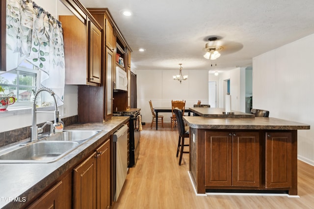 364 Berry Ridge Rd, Jonesborough, TN 37659 - kitchen featuring a sink, stainless steel dishwasher, light wood-style floors, gas range, and dark countertops