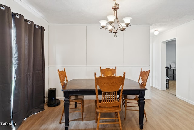 364 Berry Ridge Rd, Jonesborough, TN 37659 - dining area featuring a chandelier, light wood-style flooring, ornamental molding, and a textured ceiling