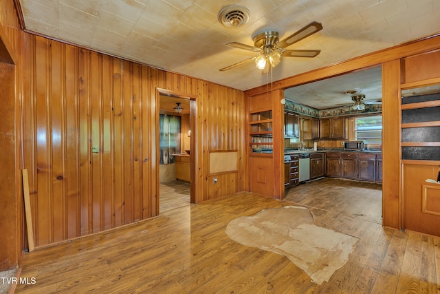 1275 Chuckey Pike, Chuckey, TN 37641 - kitchen featuring a ceiling fan, appliances with stainless steel finishes, wood finished floors, wood walls, and dark countertops