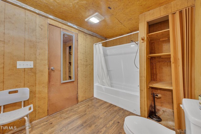 1275 Chuckey Pike, Chuckey, TN 37641 - bathroom with wood finished floors, toilet, shower / tub combo with curtain, and wooden walls