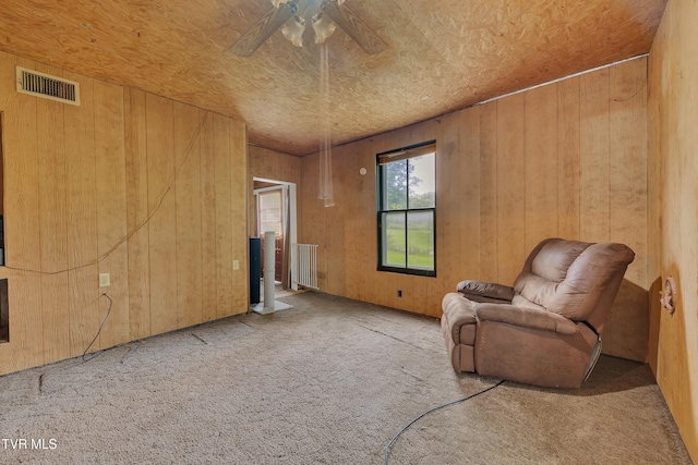 1275 Chuckey Pike, Chuckey, TN 37641 - living area with carpet floors, radiator heating unit, a ceiling fan, and wooden walls