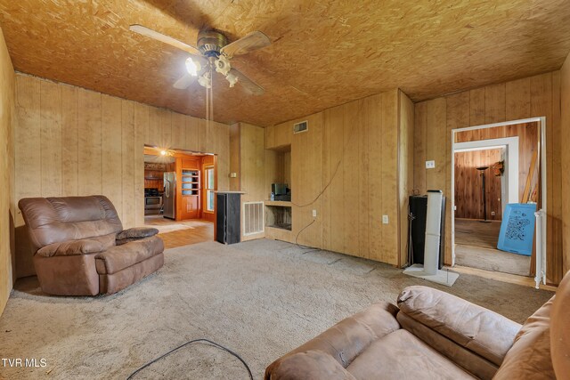 1275 Chuckey Pike, Chuckey, TN 37641 - living room with carpet flooring, ceiling fan, and wooden walls