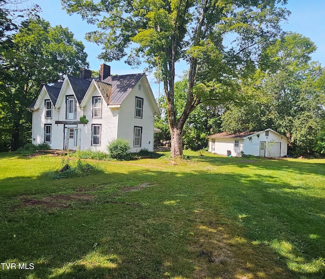 1275 Chuckey Pike, Chuckey, TN 37641 - view of grassy yard featuring an outdoor structure and a detached garage