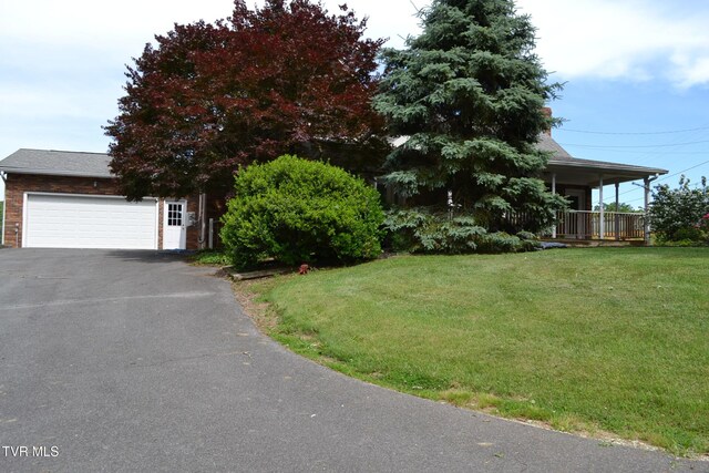 290 Kinchloe Mill Rd, Jonesborough, TN 37659 - obstructed view of property with a front lawn, driveway, a porch, brick siding, and a garage
