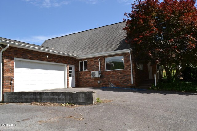 290 Kinchloe Mill Rd, Jonesborough, TN 37659 - view of front facade with brick siding, ac unit, roof with shingles, and a garage