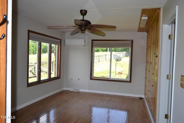 290 Kinchloe Mill Rd, Jonesborough, TN 37659 - spare room featuring a wall unit AC, hardwood / wood-style flooring, baseboards, and a ceiling fan