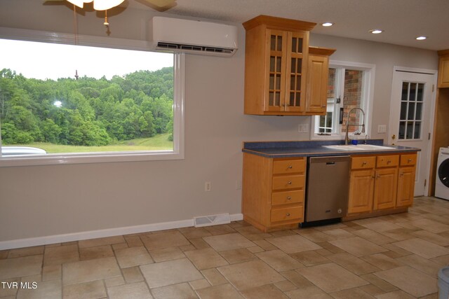 290 Kinchloe Mill Rd, Jonesborough, TN 37659 - kitchen featuring an AC wall unit, stainless steel dishwasher, a sink, washer / clothes dryer, and baseboards