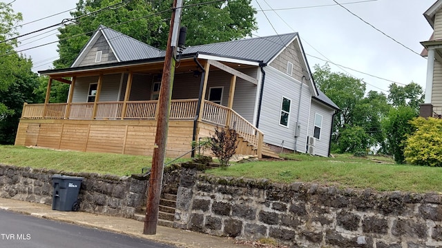 616 6th St, Bristol, TN 37620 - view of front of home with a front yard, stairs, metal roof, and a porch