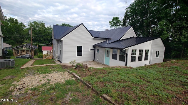 616 6th St, Bristol, TN 37620 - rear view of property with metal roof, cooling unit, and a yard