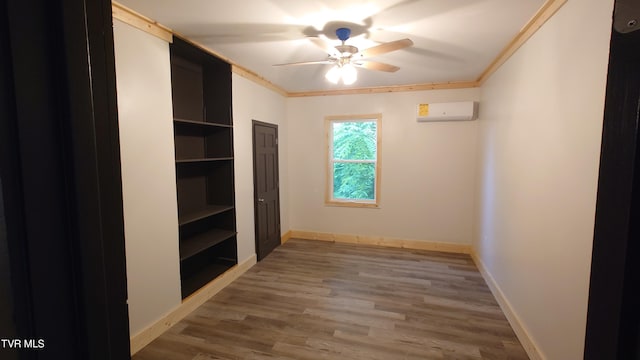 616 6th St, Bristol, TN 37620 - unfurnished room featuring a wall mounted AC, a ceiling fan, wood finished floors, baseboards, and crown molding