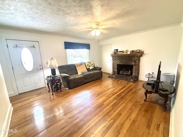 357 Martin St, Jonesville, VA 24263 - living area with a textured ceiling, wood finished floors, crown molding, ceiling fan, and a fireplace