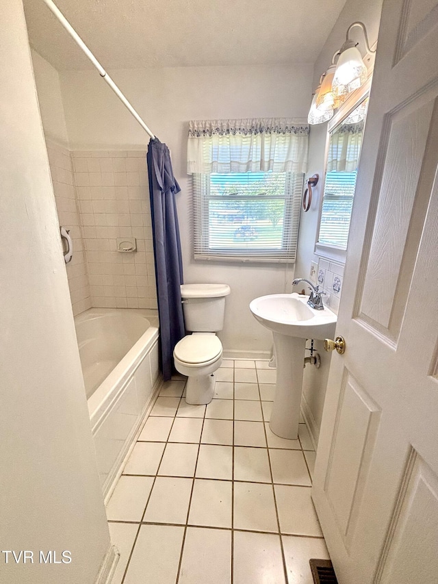 357 Martin St, Jonesville, VA 24263 - bathroom featuring tile patterned floors, toilet, shower / bathtub combination with curtain, and baseboards