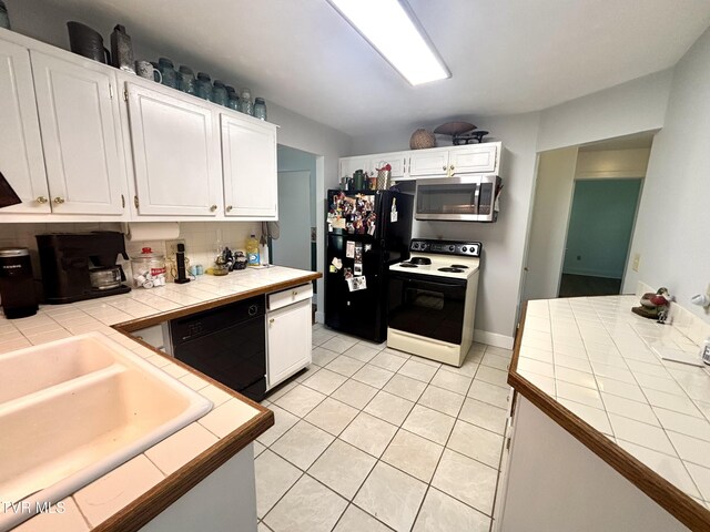 357 Martin St, Jonesville, VA 24263 - kitchen featuring black appliances, tile counters, light tile patterned floors, white cabinets, and a sink