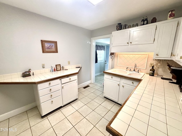 357 Martin St, Jonesville, VA 24263 - kitchen featuring tile counters, a sink, white cabinets, baseboards, and decorative backsplash
