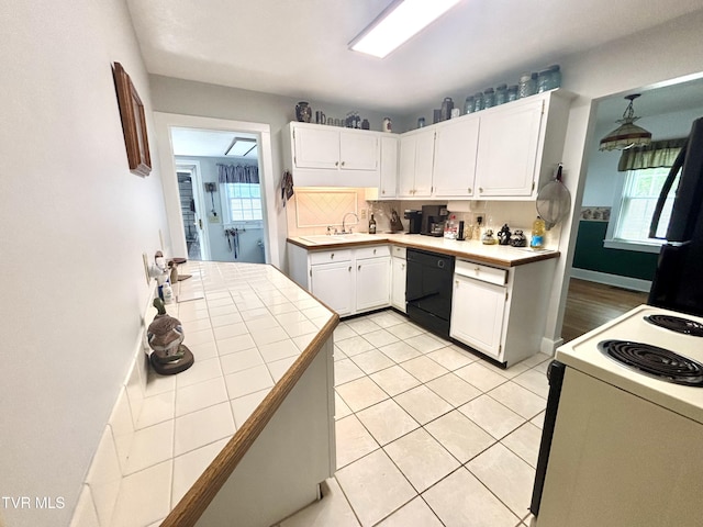 357 Martin St, Jonesville, VA 24263 - kitchen featuring black dishwasher, white range with electric stovetop, tile countertops, a sink, and white cabinetry