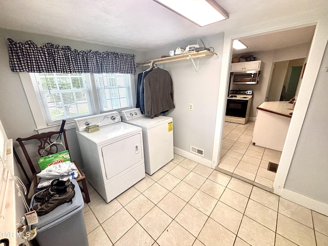 357 Martin St, Jonesville, VA 24263 - laundry area with washing machine and dryer, light tile patterned floors, and baseboards