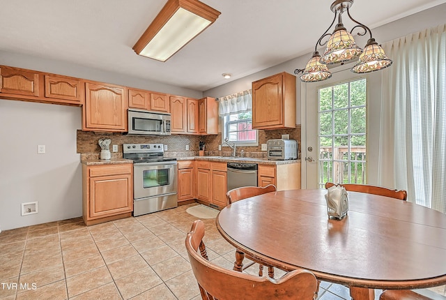 220 Amanda Ln Unit 2, Bristol, TN 37620 - kitchen with appliances with stainless steel finishes, tasteful backsplash, a sink, light countertops, and decorative light fixtures