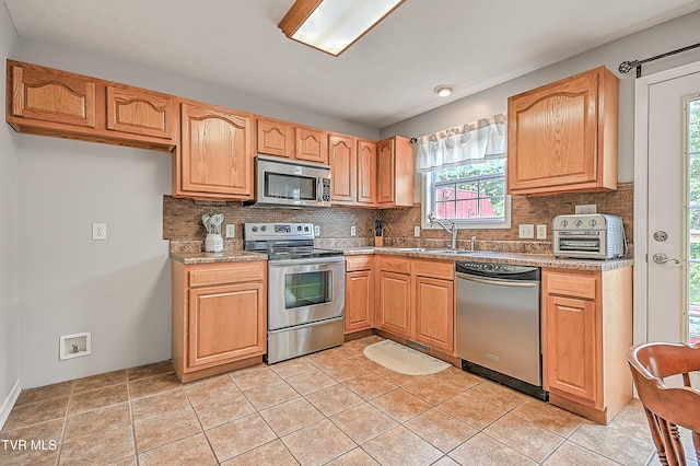 220 Amanda Ln Unit 2, Bristol, TN 37620 - kitchen with stainless steel appliances, a sink, decorative backsplash, and light tile patterned floors