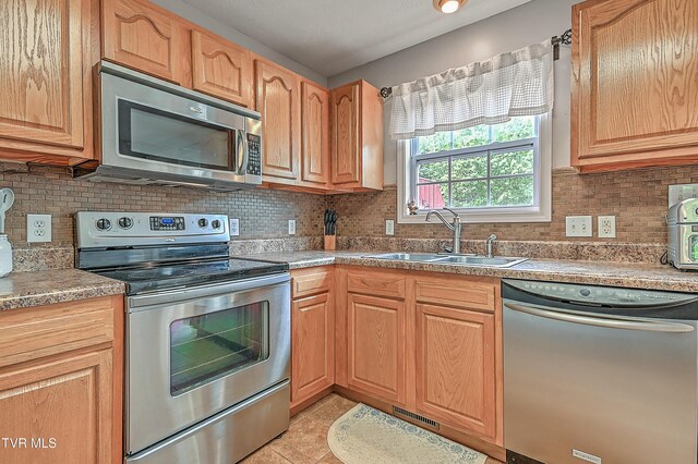 220 Amanda Ln Unit 2, Bristol, TN 37620 - kitchen featuring appliances with stainless steel finishes, a sink, tasteful backsplash, light tile patterned floors, and light countertops