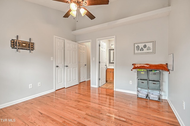 220 Amanda Ln Unit 2, Bristol, TN 37620 - unfurnished bedroom featuring light wood-style floors, baseboards, ensuite bath, a ceiling fan, and a high ceiling