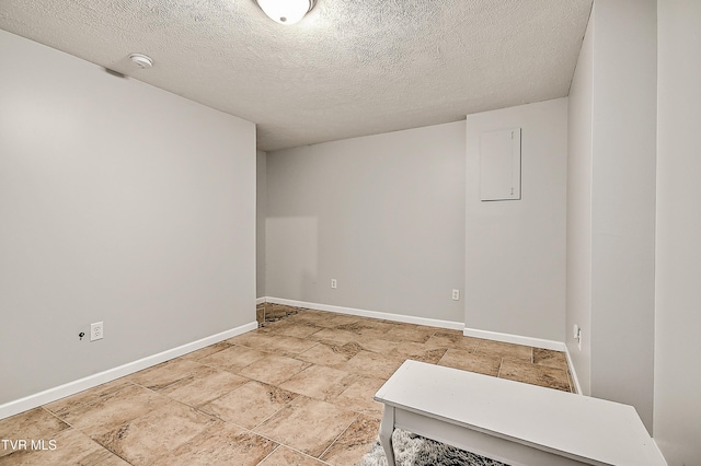 220 Amanda Ln Unit 2, Bristol, TN 37620 - empty room with baseboards, a textured ceiling, light stone finish floors, and a smoke detector