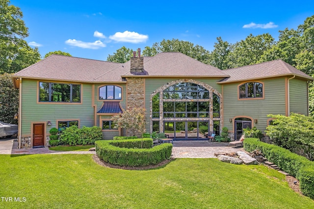 18549 Landridge Way, Abingdon, VA 24211 - rear view of house with a chimney, a patio area, and a lawn