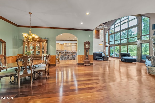 18549 Landridge Way, Abingdon, VA 24211 - dining area with wainscoting, ornamental molding, a chandelier, arched walkways, and wood finished floors