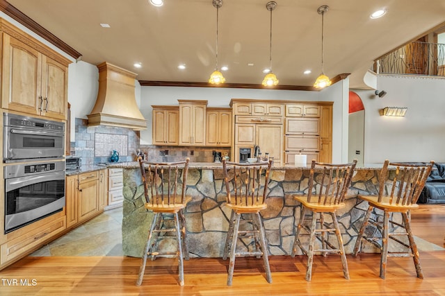18549 Landridge Way, Abingdon, VA 24211 - kitchen with premium range hood, a breakfast bar area, light stone counters, backsplash, and recessed lighting