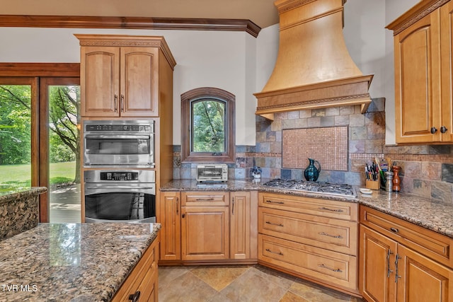 18549 Landridge Way, Abingdon, VA 24211 - kitchen featuring wall chimney range hood, stainless steel appliances, dark stone counters, backsplash, and crown molding