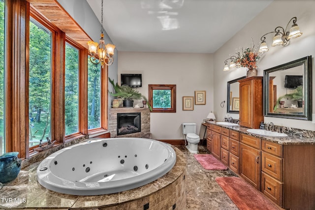 18549 Landridge Way, Abingdon, VA 24211 - full bathroom featuring a glass covered fireplace, toilet, a tub with jets, double vanity, and a chandelier