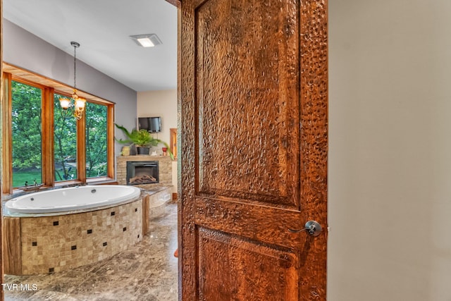 18549 Landridge Way, Abingdon, VA 24211 - full bath featuring a fireplace, a bath, and a chandelier