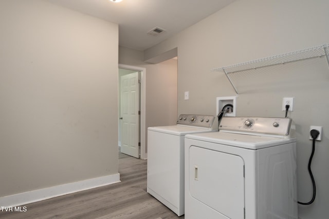 1605 E Fairview Ave, Johnson City, TN 37601 - laundry room with washer and dryer, light wood-style flooring, and baseboards
