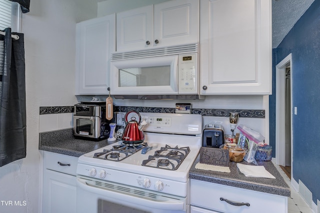 1321 Pineola Ave, Kingsport, TN 37664 - kitchen featuring white appliances, white cabinets, and dark countertops