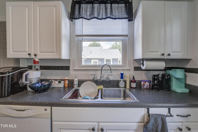 1321 Pineola Ave, Kingsport, TN 37664 - kitchen featuring white dishwasher, a sink, white cabinets, and dark countertops