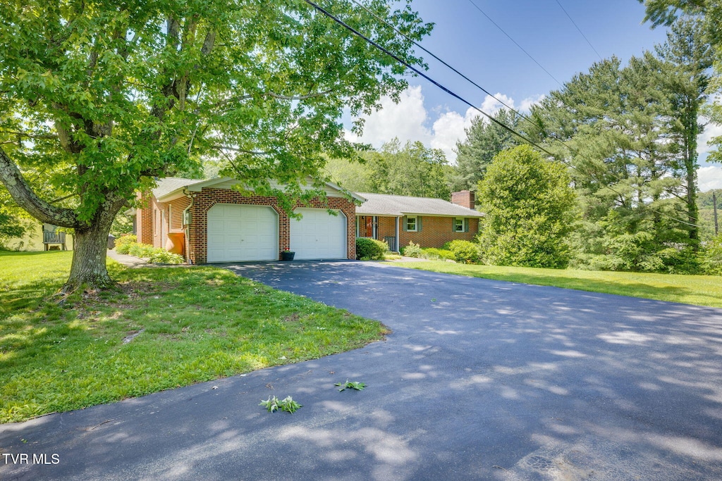 632 Cox Hollow Rd, Kingsport, TN 37663 - view of front of property featuring a garage, brick siding, asphalt driveway, a front yard, and a chimney