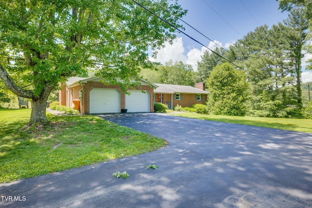 632 Cox Hollow Rd, Kingsport, TN 37663 - view of front of property featuring a garage, brick siding, asphalt driveway, a front yard, and a chimney