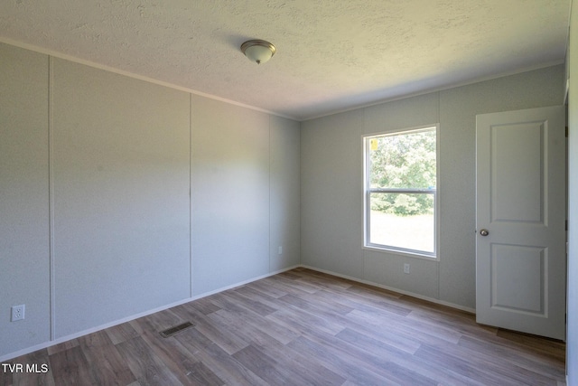 385 Piney Grove Rd, Greeneville, TN 37743 - empty room featuring wood finished floors, a textured ceiling, baseboards, and crown molding