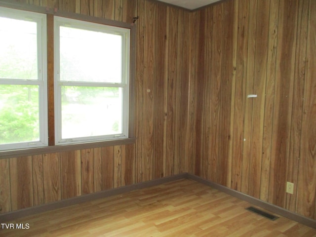 19374 Benhams Rd, Bristol, VA 24202 - unfurnished room with light wood-style flooring and wooden walls
