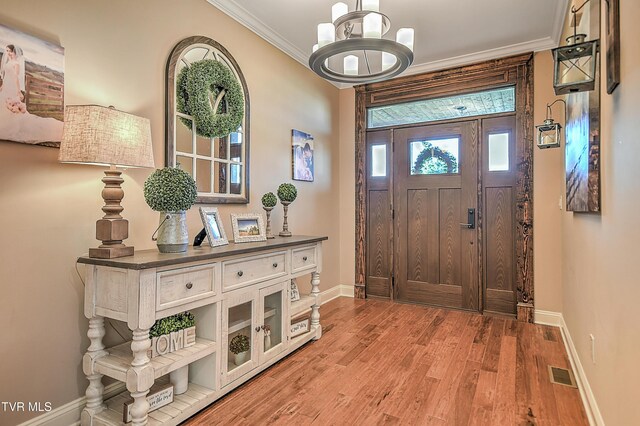 133 Christopher Way, Blountville, TN 37617 - foyer with baseboards, crown molding, light wood finished floors, and a chandelier