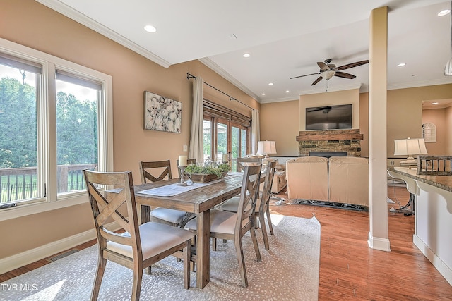 133 Christopher Way, Blountville, TN 37617 - dining space featuring a fireplace, light wood finished floors, ceiling fan, crown molding, and baseboards