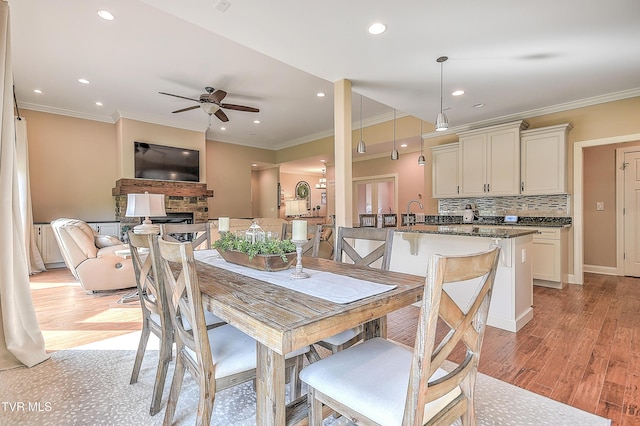 133 Christopher Way, Blountville, TN 37617 - dining space featuring ceiling fan, a fireplace, light wood-type flooring, ornamental molding, and recessed lighting