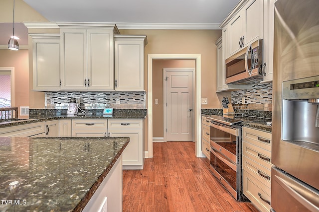 133 Christopher Way, Blountville, TN 37617 - kitchen with appliances with stainless steel finishes, ornamental molding, wood finished floors, tasteful backsplash, and dark stone counters